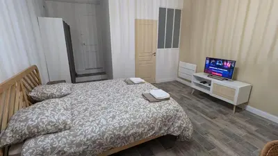 a bedroom with a bed and a flat screen tv at Studio centre de Charleval in Charleval