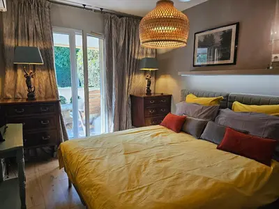 a bedroom with a bed and a desk and lamps at Aix centre, 2 room apartment garden, parking in Aix-en-Provence