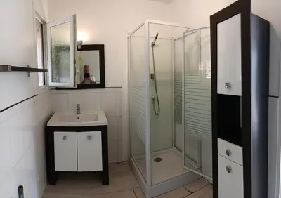 a white bathroom with a shower and a sink at Maison provençale de charme in Velaux