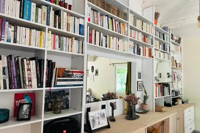 a room with white shelves filled with books at House with heated swimming pool and breathtaking views of the Luberon in Robion en Luberon