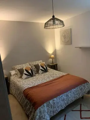 a bedroom with a bed and a pendant light at Location maison provençale in Plan-dʼOrgon