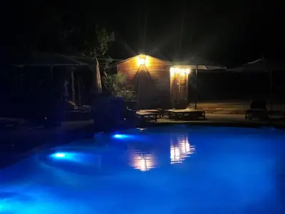 a swimming pool at night with blue lights at Le Mas des iscles Mallemort in Mallemort