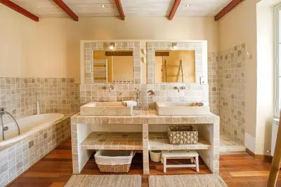 a bathroom with two sinks and a bath tub and a tubermott at Mas des Olivades - Ferme Provençale - Piscine in Pernes-les-Fontaines