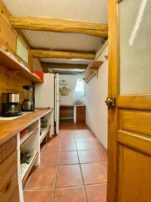 a kitchen with a refrigerator and a tile floor at Mas des Olivades - Ferme Provençale - Piscine in Pernes-les-Fontaines