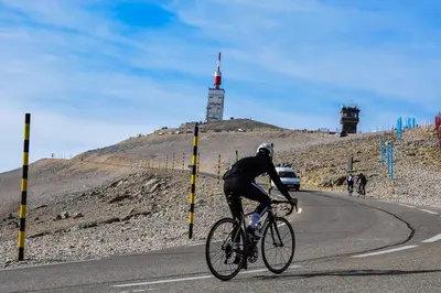 a man riding a bike down a road at Résidence Les Salettes in Mormoiron