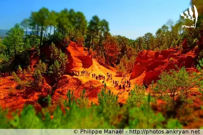 a group of people walking on a red rocks at Résidence Les Salettes in Mormoiron