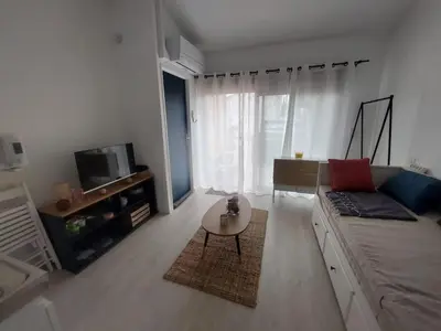 a living room with a couch and a coffee table at Studio 25m2 in LʼIsle-sur-la-Sorgue