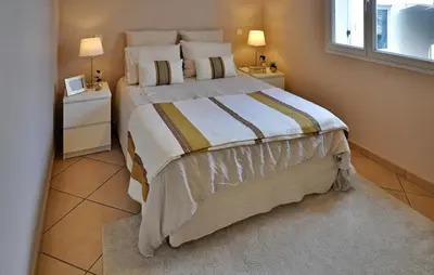 a bedroom with a large bed with two night stands at villa in Châteauneuf-de-Gadagne