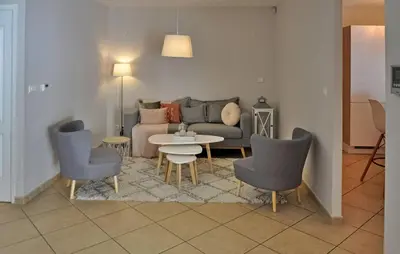 a living room with a couch and chairs and a table at villa in Châteauneuf-de-Gadagne