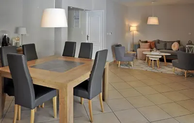 a living room with a wooden table and chairs at villa in Châteauneuf-de-Gadagne