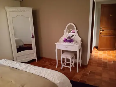 a bedroom with a dressing table and a mirror at LE Mas Pacha in LʼIsle-sur-la-Sorgue