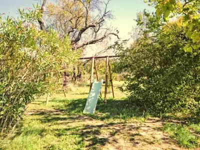 a swing set in the middle of a field at Gîte en Provence entre Pernes les fontaines et St Didier proche l'isle sur sorgues face Mont Ventoux Villa avec piscine in Saint-Didier