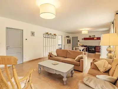 a living room with a couch and a table at Gîte en Provence entre Pernes les fontaines et St Didier proche l'isle sur sorgues face Mont Ventoux Villa avec piscine in Saint-Didier