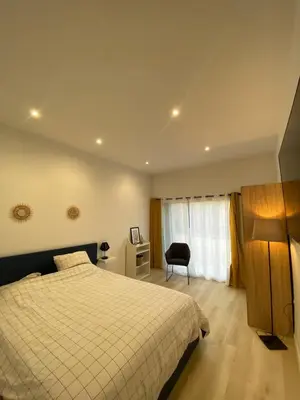 a bedroom with a bed and a desk and a chair at Studio en Provence avec piscine in La Barben