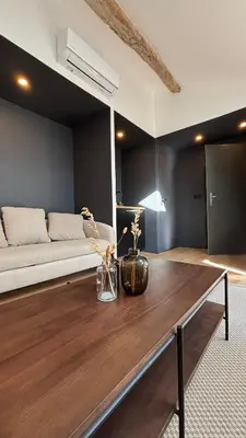 a living room with a couch and a table at Le Granier location in Robion en Luberon