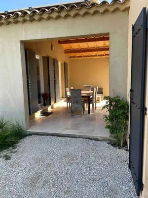 a patio with a table and chairs on it at Petite maison au calme avec piscine privative in Saint-Rémy-de-Provence