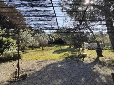 a view of a park with trees and a swing at fleur de gaïa chambres d'hôtes in Mazan