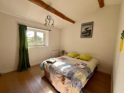a bedroom with a bed and a window at Très beau mas à Bonnieux in Bonnieux