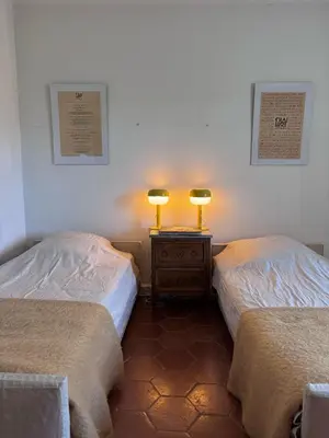 two beds in a room with two lamps on a night stand at Mas exceptionnel à Lagnes, Provence in Lagnes