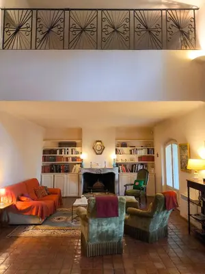 a living room with a couch and a fireplace at Maison Robert in La Tour-dʼAigues