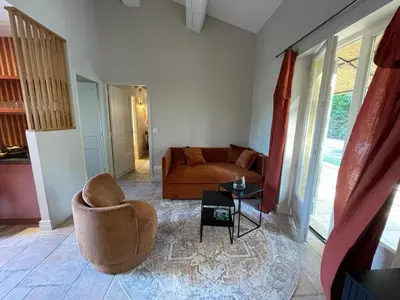 a living room with a couch and a chair at Mazet Arlequine in Eygalières