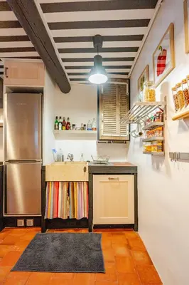 a kitchen with a refrigerator and a counter top at Ecrin au cœur d'Aix-Vue sur la Place de la Mairie in Aix-en-Provence