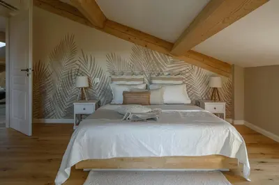 a bedroom with a large bed and two night stands at La Bastide Mas in Le Thor