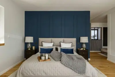 a bedroom with a large bed with blue walls at La Bastide Mas in Le Thor