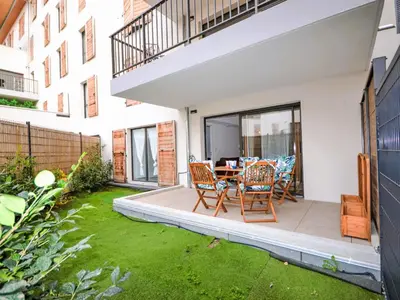 a patio with a table and chairs in a backyard at Apartment Pigonnet by Interhome in Aix-en-Provence