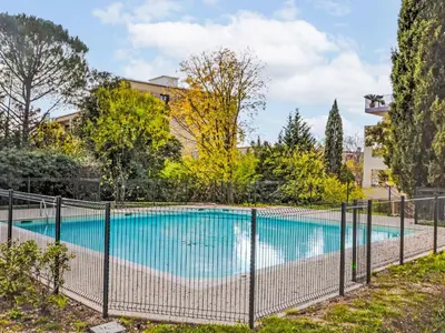 a swimming pool with a fence around it at Apartment Pigonnet by Interhome in Aix-en-Provence