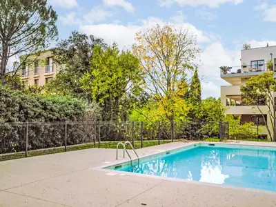 a swimming pool in front of a building at Apartment Pigonnet by Interhome in Aix-en-Provence