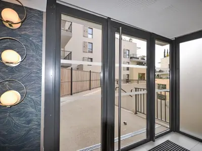 a room with sliding glass doors looking out onto a balcony at Apartment Pigonnet by Interhome in Aix-en-Provence