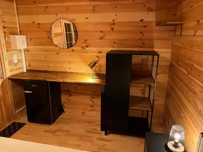 a desk in a room with a wooden wall at villa spacieuse piscine jacuzzi 8 chambres 16 couchages in Saint-Chamas