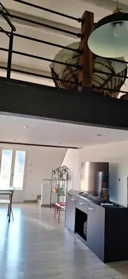 a large room with a kitchen with a table and chairs at Complexe dans un grand Mas Provençal en campagne avec piscine privée in Monteux