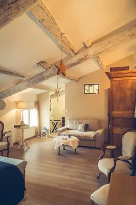 a living room with a couch and a table at CHAMBRES D'HÔTES L'Oréliane en Provence Adults Only in Châteauneuf-de-Gadagne