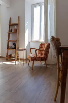 a living room with a chair and a window at CHAMBRES D'HÔTES L'Oréliane en Provence Adults Only in Châteauneuf-de-Gadagne