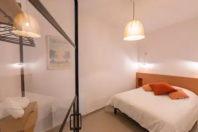 a bedroom with a bed and two lamps and a mirror at Charme et Modernité au coeur d'Aix & Cours Mirabeau in Aix-en-Provence