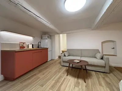 a living room with a couch and a table at Magnifique studio centre d'Aix & Cours Mirabeau in Aix-en-Provence