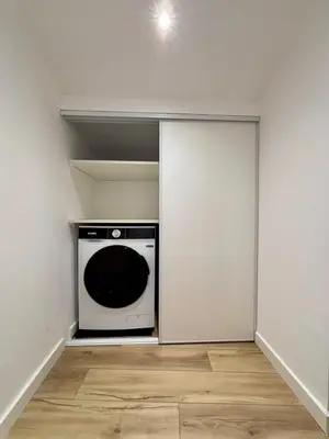 a laundry room with a white wall and a microwave at Magnifique studio centre d'Aix & Cours Mirabeau in Aix-en-Provence