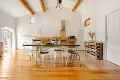 a kitchen with a dining room table and chairs at Gite dans un Mas Provençal avec Jacuzzi in Oppède