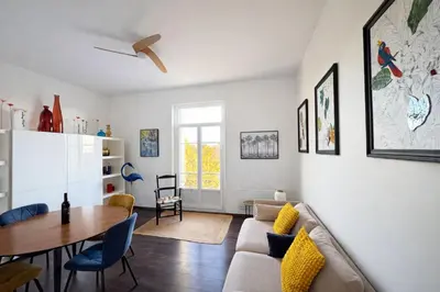 a living room with a table and a couch at Cozy apartment in LʼIsle-sur-la-Sorgue
