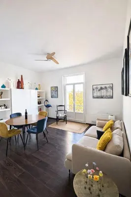 a living room with a table and a couch at Cozy apartment in LʼIsle-sur-la-Sorgue