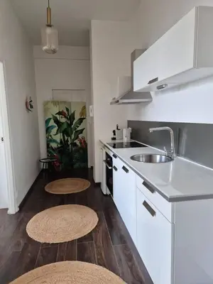 a kitchen with a sink and a stove at Cozy apartment in LʼIsle-sur-la-Sorgue