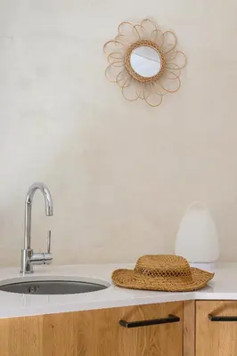 a bathroom sink with a straw hat and a mirror at Gîte de charme face au Luberon, avec Jacuzzi in Oppède