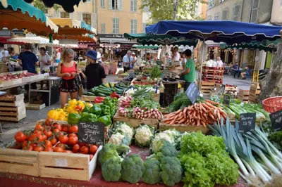 a market with fruits and vegetables on display at Le Jardinet de la Cathédrale in Aix-en-Provence