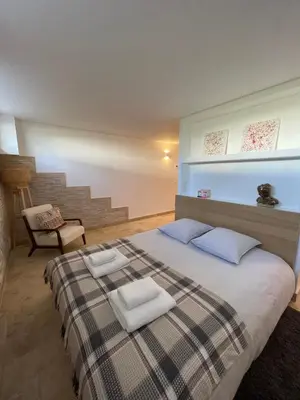 a bedroom with a bed with two towels on it at Duplex indépendant avec clim et parking St Donat in Aix-en-Provence