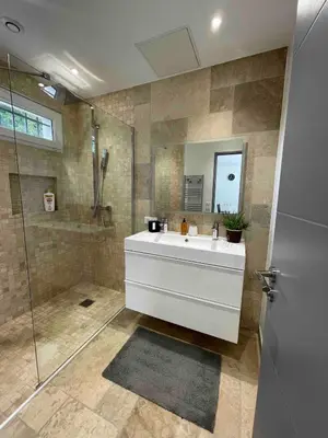 a bathroom with a white sink and a shower at Duplex indépendant avec clim et parking St Donat in Aix-en-Provence