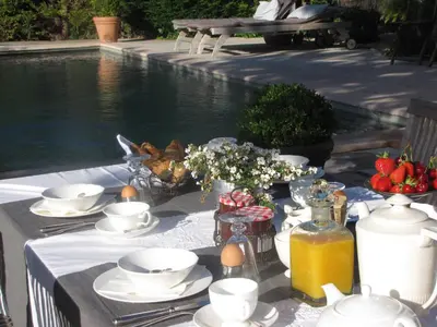 a table with plates of food next to a pool at 
