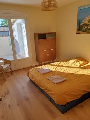a bedroom with a bed with two towels on it at Charming house near village with 5-minutes pedestrian access to old town in Venelles