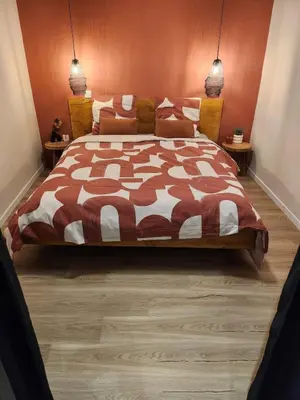 a bedroom with a large bed with a brown and white comforter at Escapade sur la Sorgue in LʼIsle-sur-la-Sorgue